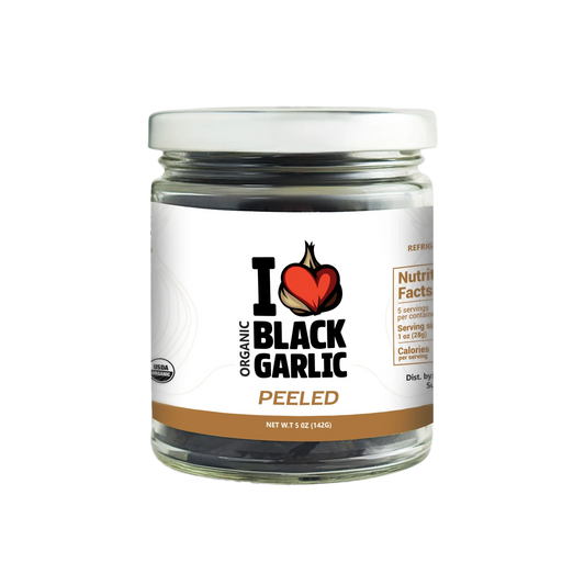 Jar of organic black garlic with a clear label on a white background